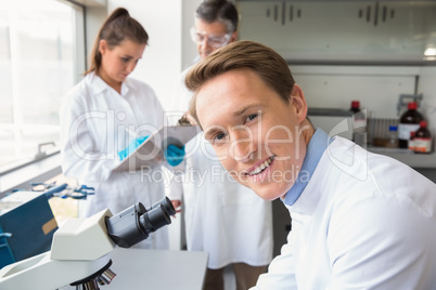 Scientist looking through a microscope