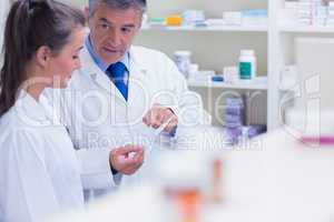 Pharmacist explaining a prescription to his trainee