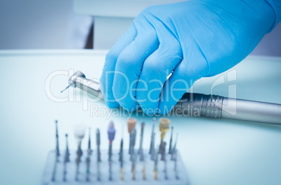 Gloved hand picking dental tools