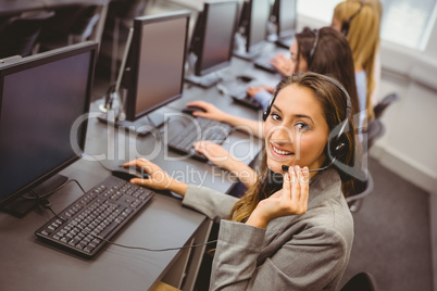 Smiling call centre agent talking on the headset