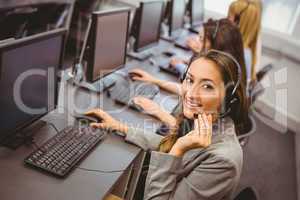 Smiling call centre agent talking on the headset