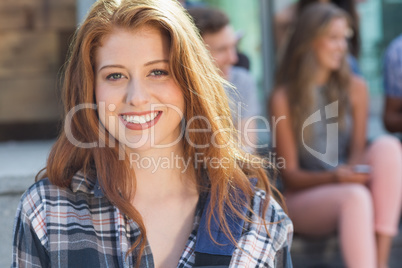 Pretty student smiling at camera outside