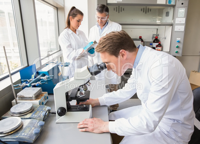 Scientist looking through a microscope