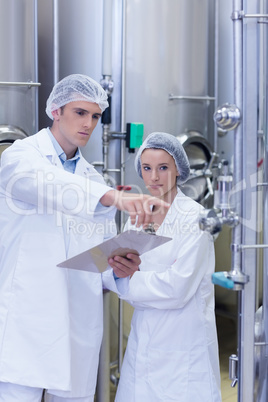 Man pointing at something to his colleague