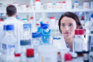 Portrait of a chemist behind medical sample