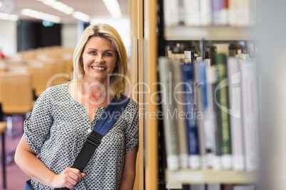 Mature student studying in the library with tablet