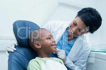 Female dentist examining boys teeth