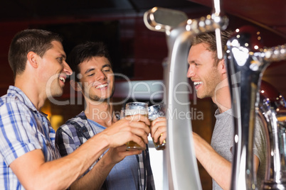 Happy friends toasting with pints of beer