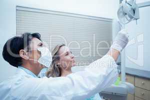 Female dentist showing woman her mouth x-ray
