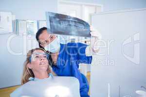 Dentist explaining x-ray to patient