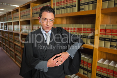 Lawyer looking at camera in the law library