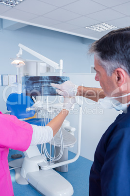 Dentist pointing something at x-ray