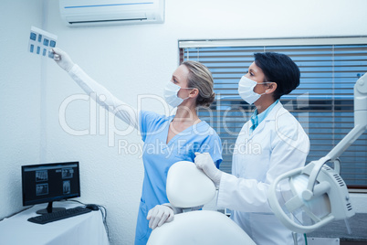 Concentrated dentists looking at x-ray