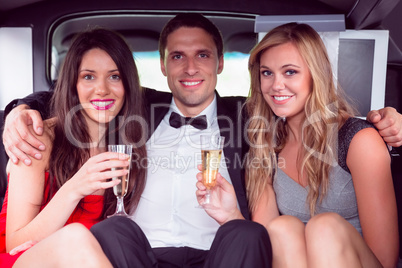 Pretty girls with ladies man in the limousine