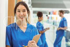 Medical student smiling at camera in hallway