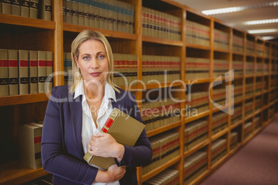 Female librarian posing and holding a book