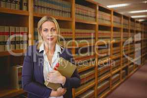 Female librarian posing and holding a book