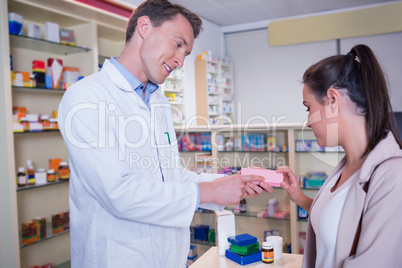 Pharmacist and customer discussing a product