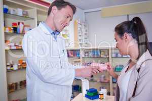 Pharmacist and customer discussing a product