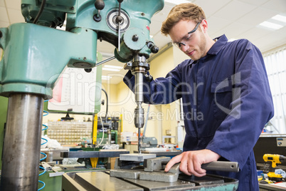 Engineering student using large drill