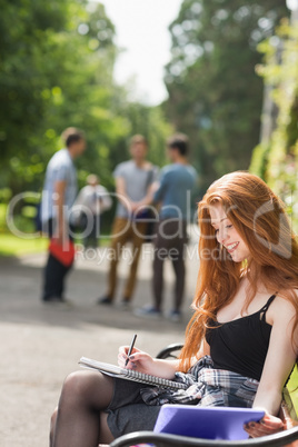 Pretty student studying outside on campus