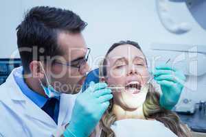 Dentist examining young womans teeth