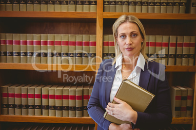 Portrait of a librarian posing and holding a book