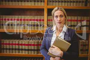 Portrait of a librarian posing and holding a book