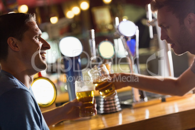 Happy friends catching up over pints