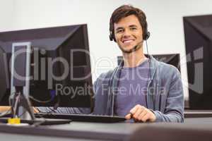 Student sitting at the computer room wearing headset