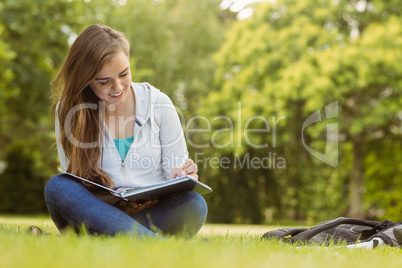 Smiling student sitting and reading book