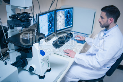 Science student looking at microscopic images