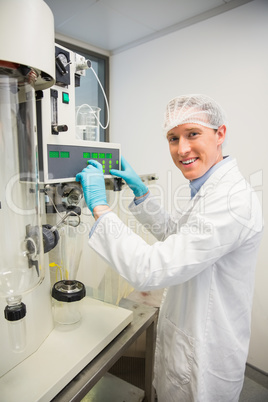 Pharmacist using machinery to make medicine