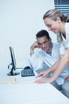 Smiling dentists using computer