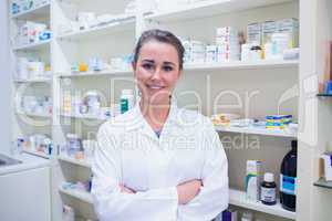 Portrait of a smiling student in lab coat with arms crossed