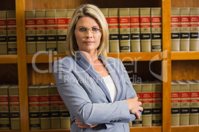 Lawyer looking at camera in law library