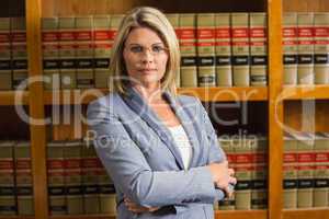 Lawyer looking at camera in law library