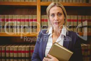 Portrait of a librarian posing and holding a book