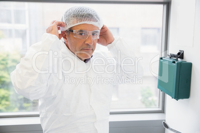 Pharmacist putting on his hairnet