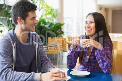 Young students having coffee together