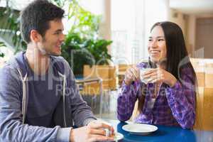 Young students having coffee together