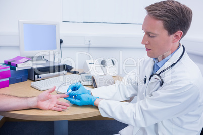 Doctor testing his patients blood