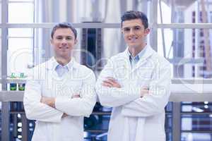 Scientist team smiling at camera with arms crossed