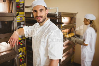 Handsome baker smiling at camera