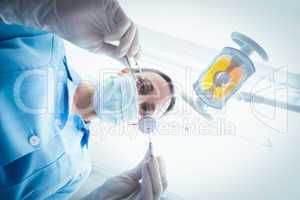 Female dentist in surgical mask holding dental tools