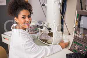 Biochemistry student using large microscope