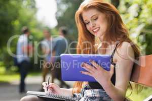 Pretty student studying outside on campus