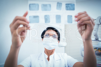 Female dentist looking at x-ray