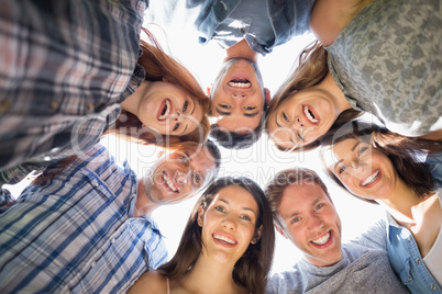 Happy students smiling at camera in a circle