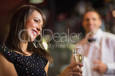 Pretty brunette smiling with champagne